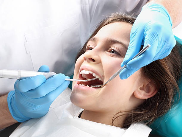 Child receiving dental treatment in a dental chair